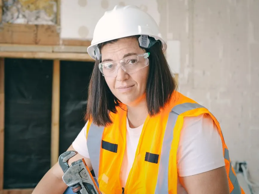 Plumber in a hard hat and safety vest